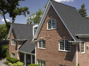 A two-story brick home with a new black asphalt shingle roof