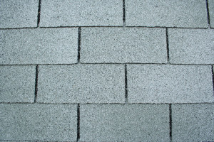 Close up view of grey asphalt roof shingles 