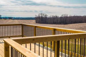 A composite deck with view of a large lawn