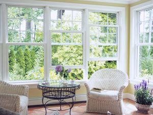 The seating area of a home with new windows that feature white frames