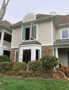 Two story home with open casement windows